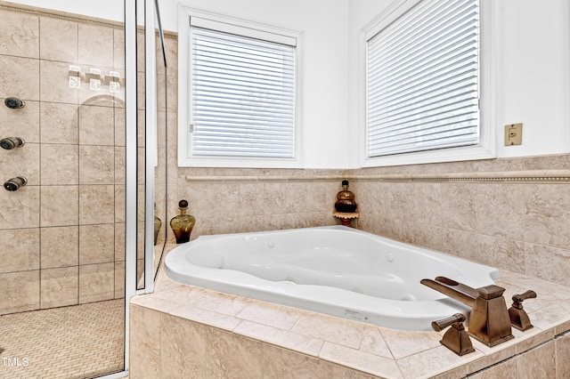 bathroom featuring shower with separate bathtub