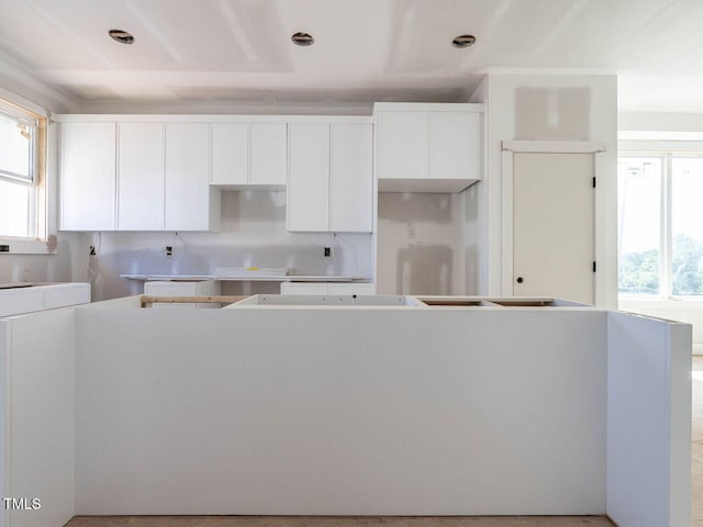 kitchen with a center island and white cabinets