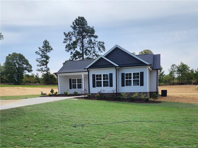 view of front of home with a front lawn and concrete driveway