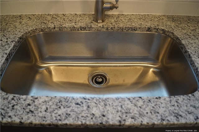 details with light stone counters and a sink