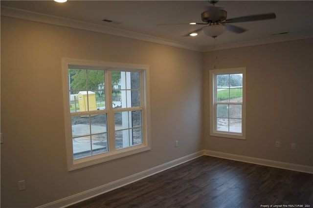 spare room featuring dark wood-style flooring, a ceiling fan, baseboards, and ornamental molding