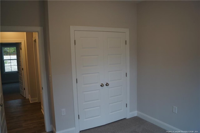 unfurnished bedroom featuring a closet and baseboards