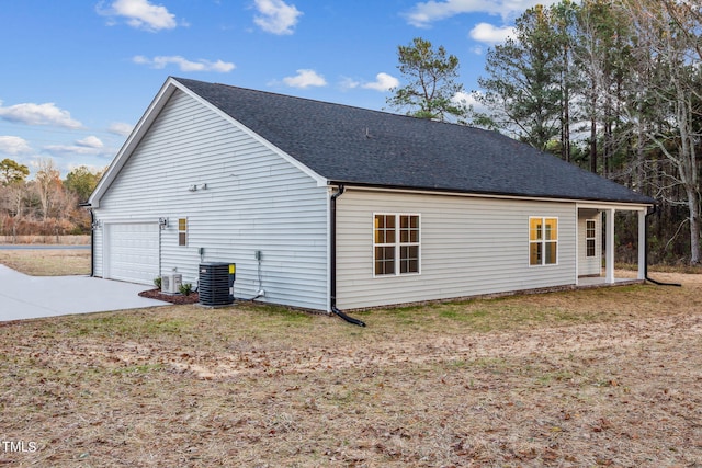 view of property exterior featuring a garage and central AC unit