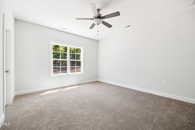 spare room featuring carpet flooring and ceiling fan