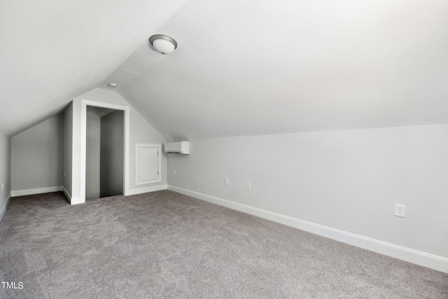 additional living space with lofted ceiling, an AC wall unit, and carpet flooring