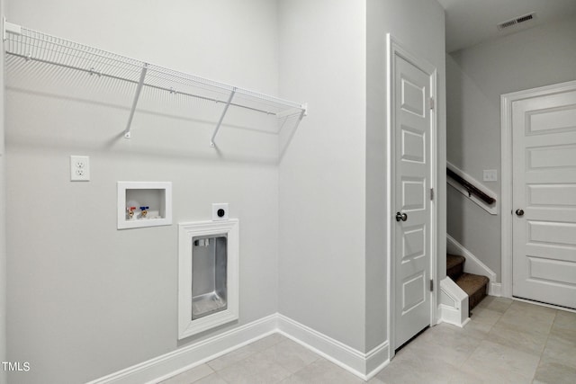 washroom featuring hookup for a washing machine, electric dryer hookup, and light tile patterned floors