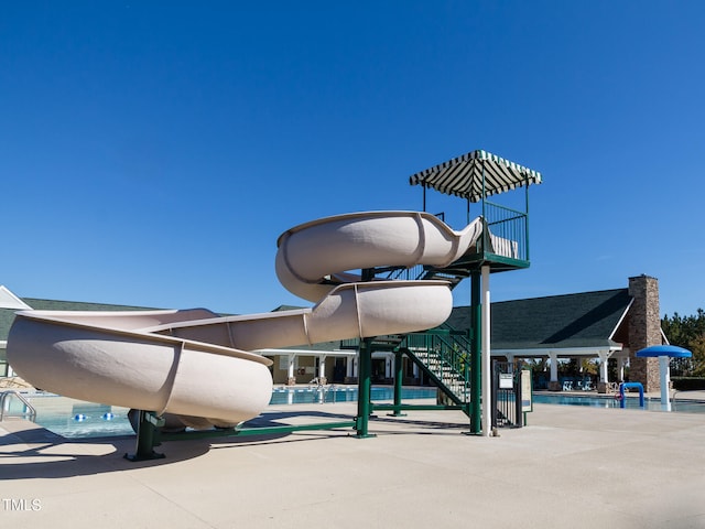 view of building exterior featuring a community pool