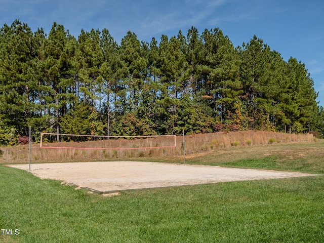 surrounding community featuring volleyball court and a yard