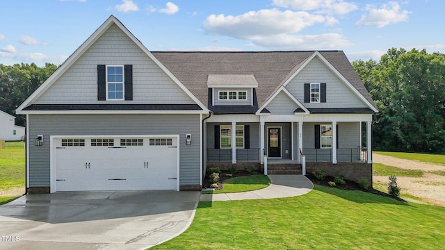 craftsman-style house with covered porch, a garage, and a front yard