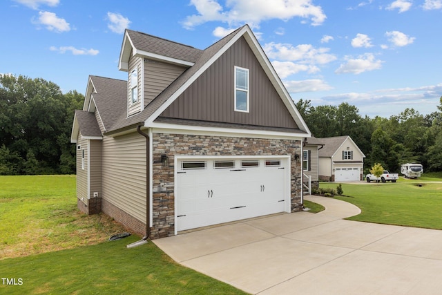 view of side of property featuring a garage and a yard