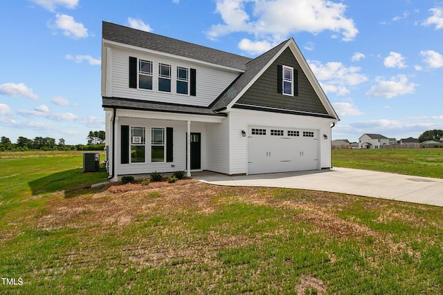 craftsman inspired home with a front lawn, central AC unit, and a garage