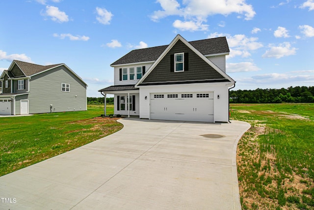 view of front of house featuring a front yard and a garage