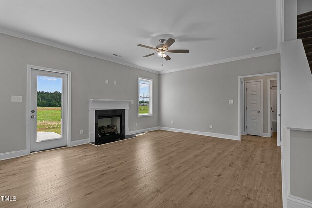 unfurnished living room featuring light hardwood / wood-style flooring, crown molding, and ceiling fan