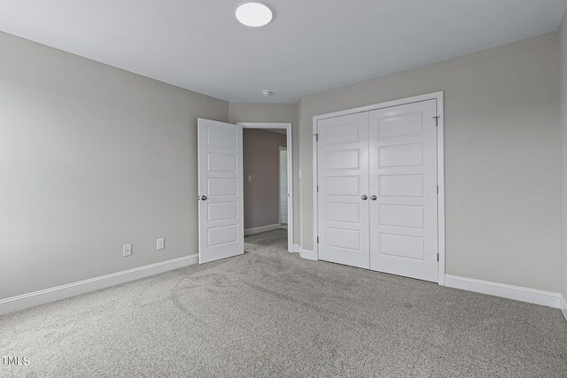 unfurnished bedroom featuring a closet and carpet