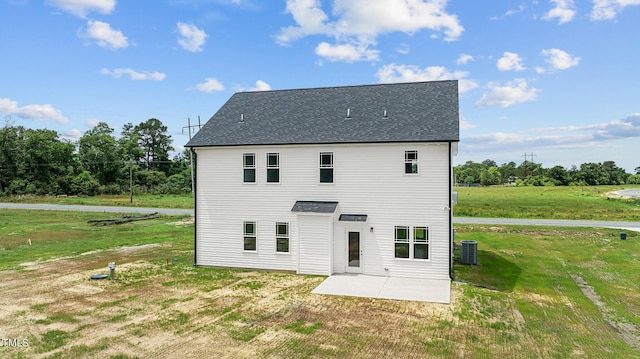 back of property featuring cooling unit, a patio area, and a lawn