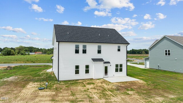 rear view of house featuring a patio and a yard