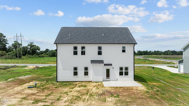 rear view of house featuring a patio and a yard