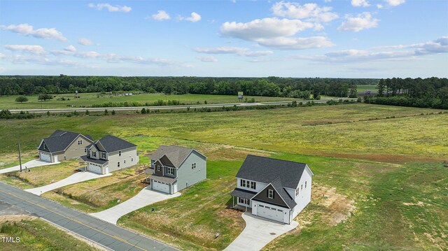 birds eye view of property with a rural view