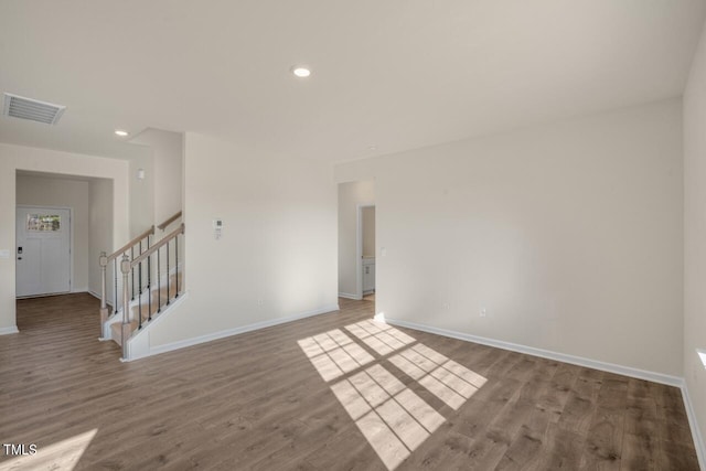 unfurnished room with wood-type flooring