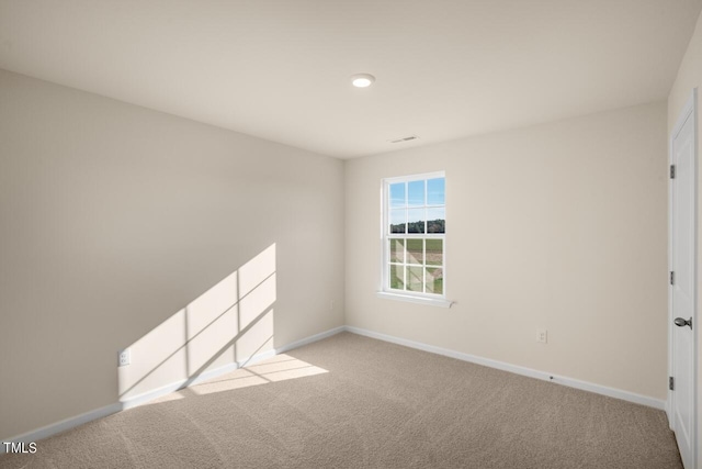 unfurnished room with light carpet