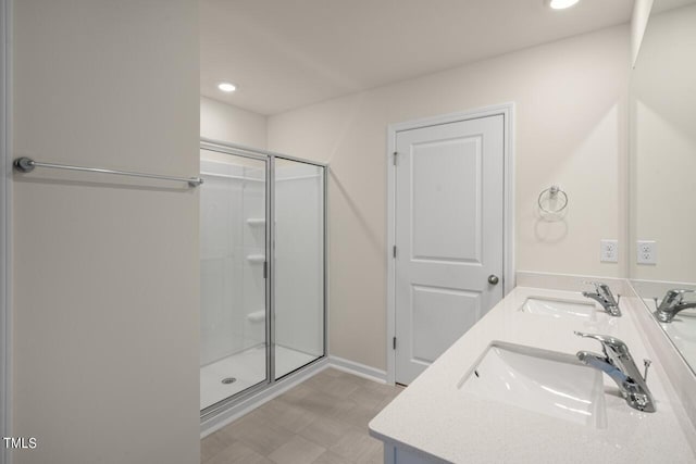 bathroom featuring vanity and an enclosed shower