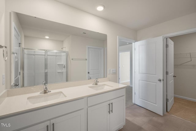 bathroom with a shower with door and vanity