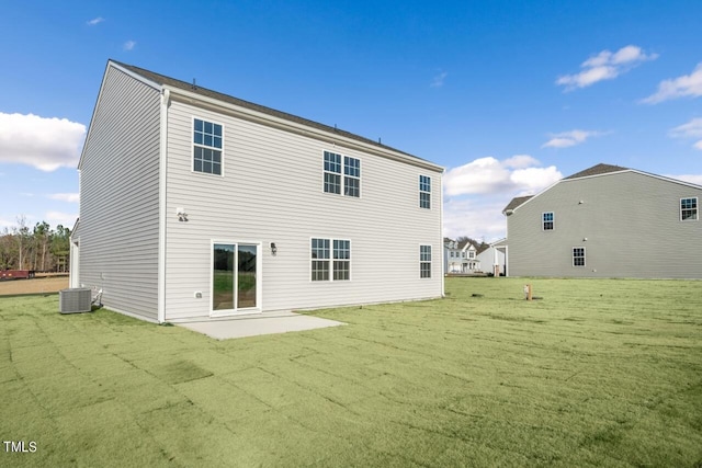 rear view of property featuring central AC, a patio, and a lawn