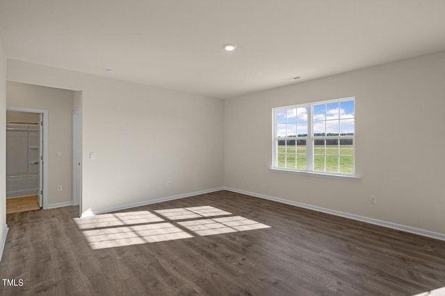 spare room with dark hardwood / wood-style floors