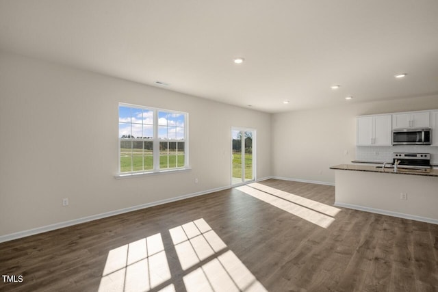 unfurnished living room featuring dark hardwood / wood-style flooring