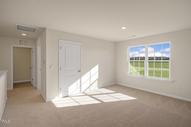 empty room featuring light colored carpet