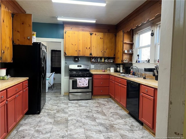 kitchen with tasteful backsplash, sink, light tile floors, and black appliances