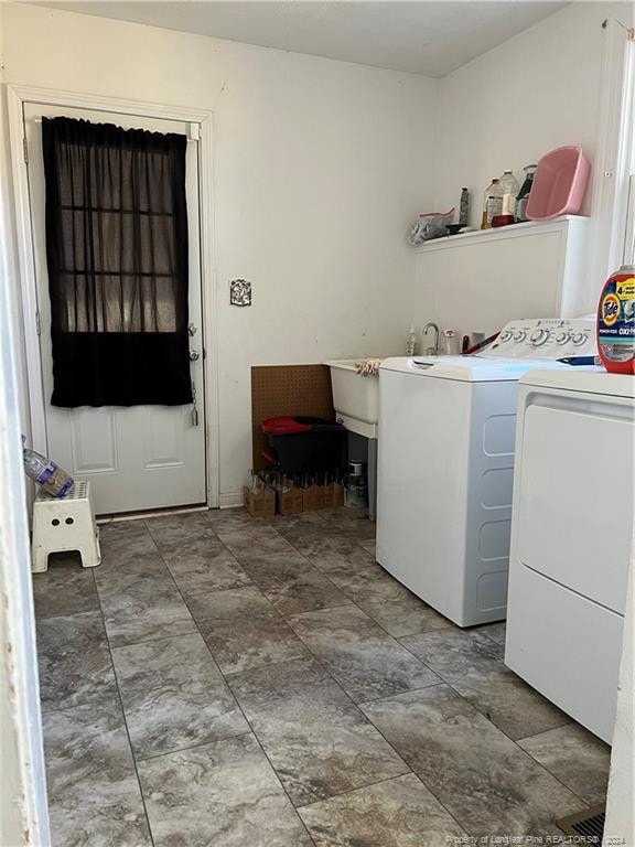 clothes washing area with tile floors and independent washer and dryer