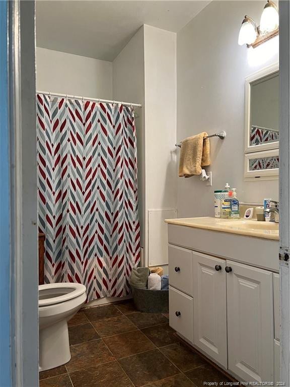 bathroom with vanity, tile flooring, and toilet