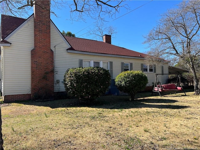 view of side of home featuring a yard