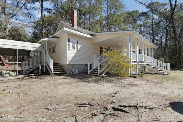 view of side of property with covered porch