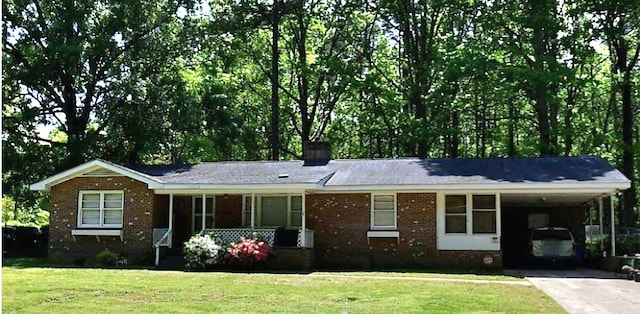 ranch-style home featuring a carport and a front yard