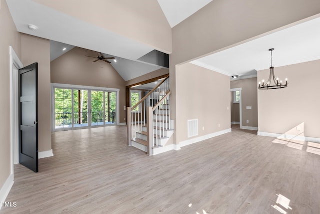 unfurnished living room with crown molding, high vaulted ceiling, ceiling fan with notable chandelier, and light wood-type flooring