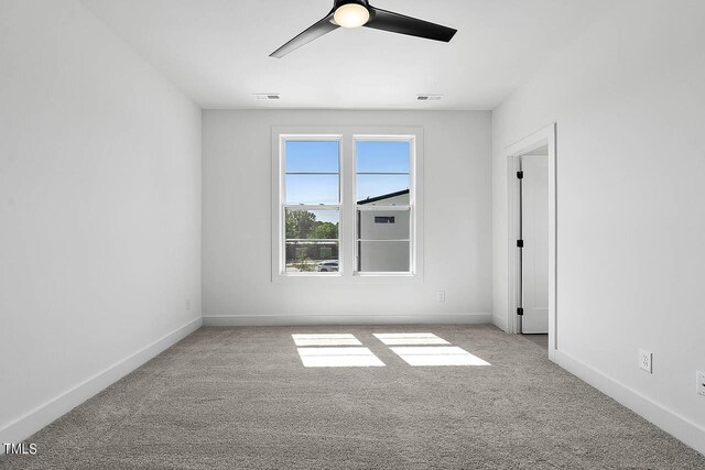 unfurnished room featuring ceiling fan and light carpet