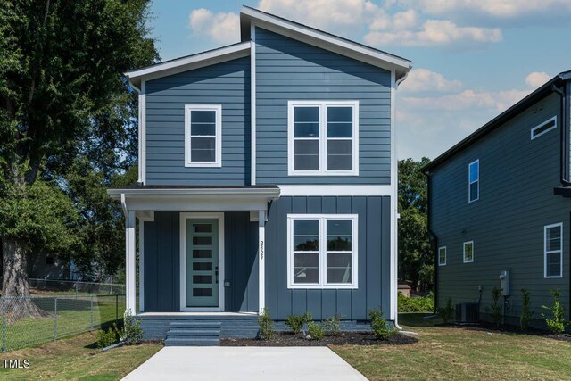 view of front of house with central air condition unit and a front yard