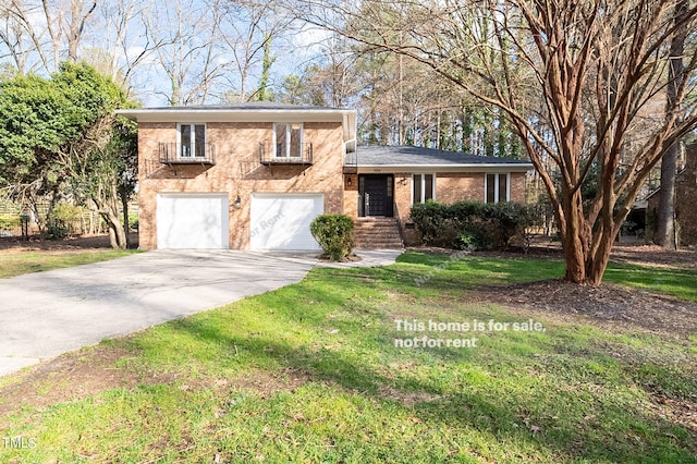 view of front of home with a front yard and a garage