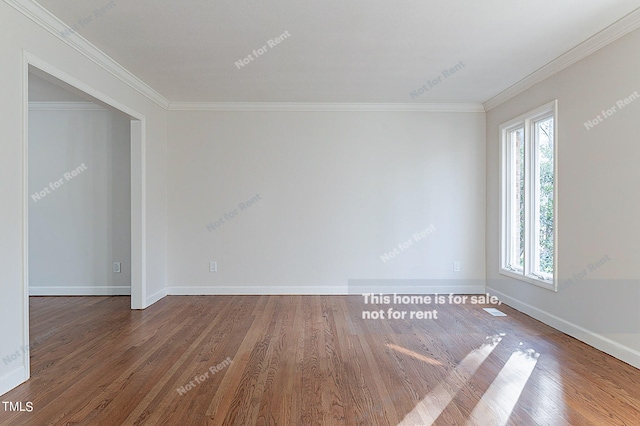 spare room with crown molding and dark wood-type flooring