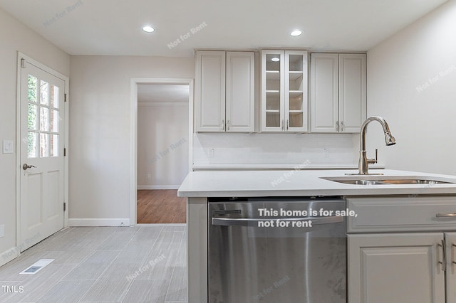 kitchen with sink, gray cabinetry, light hardwood / wood-style floors, and dishwasher