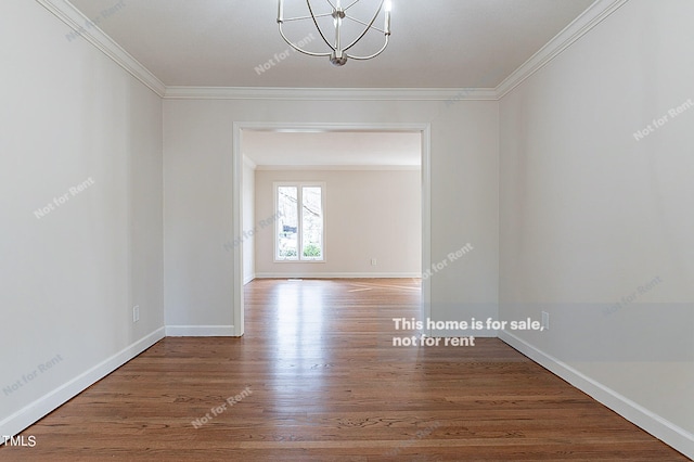 unfurnished room with an inviting chandelier, dark hardwood / wood-style flooring, and ornamental molding