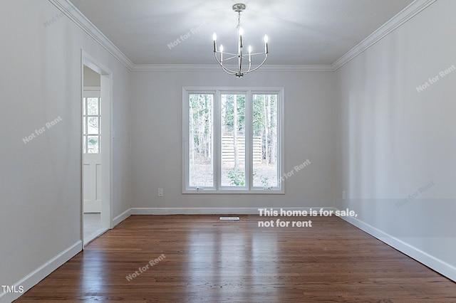 empty room with crown molding, dark hardwood / wood-style flooring, and a chandelier