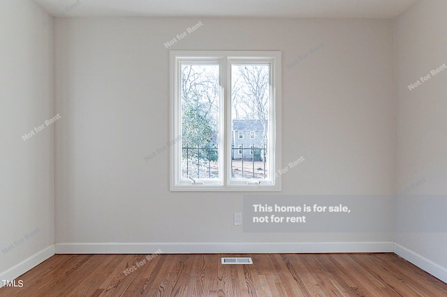 spare room featuring light hardwood / wood-style flooring