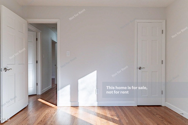 unfurnished room featuring dark wood-type flooring