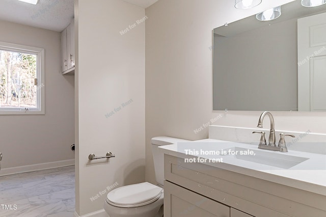 bathroom featuring a textured ceiling, toilet, tile floors, and vanity with extensive cabinet space