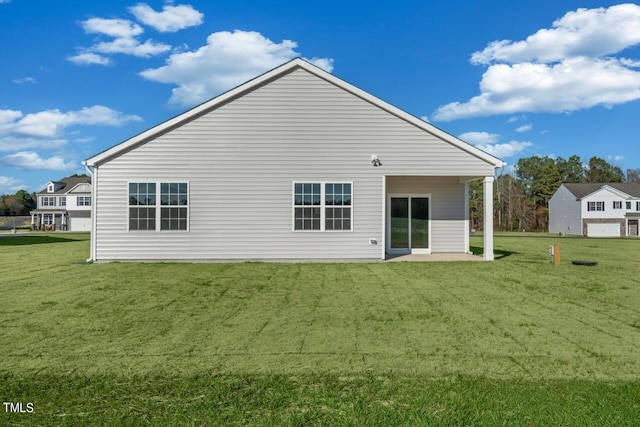 back of house with a lawn