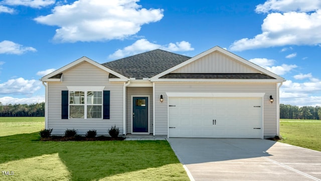 view of front of property featuring a garage and a front lawn