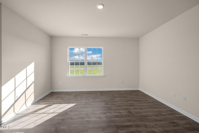 spare room with dark hardwood / wood-style flooring